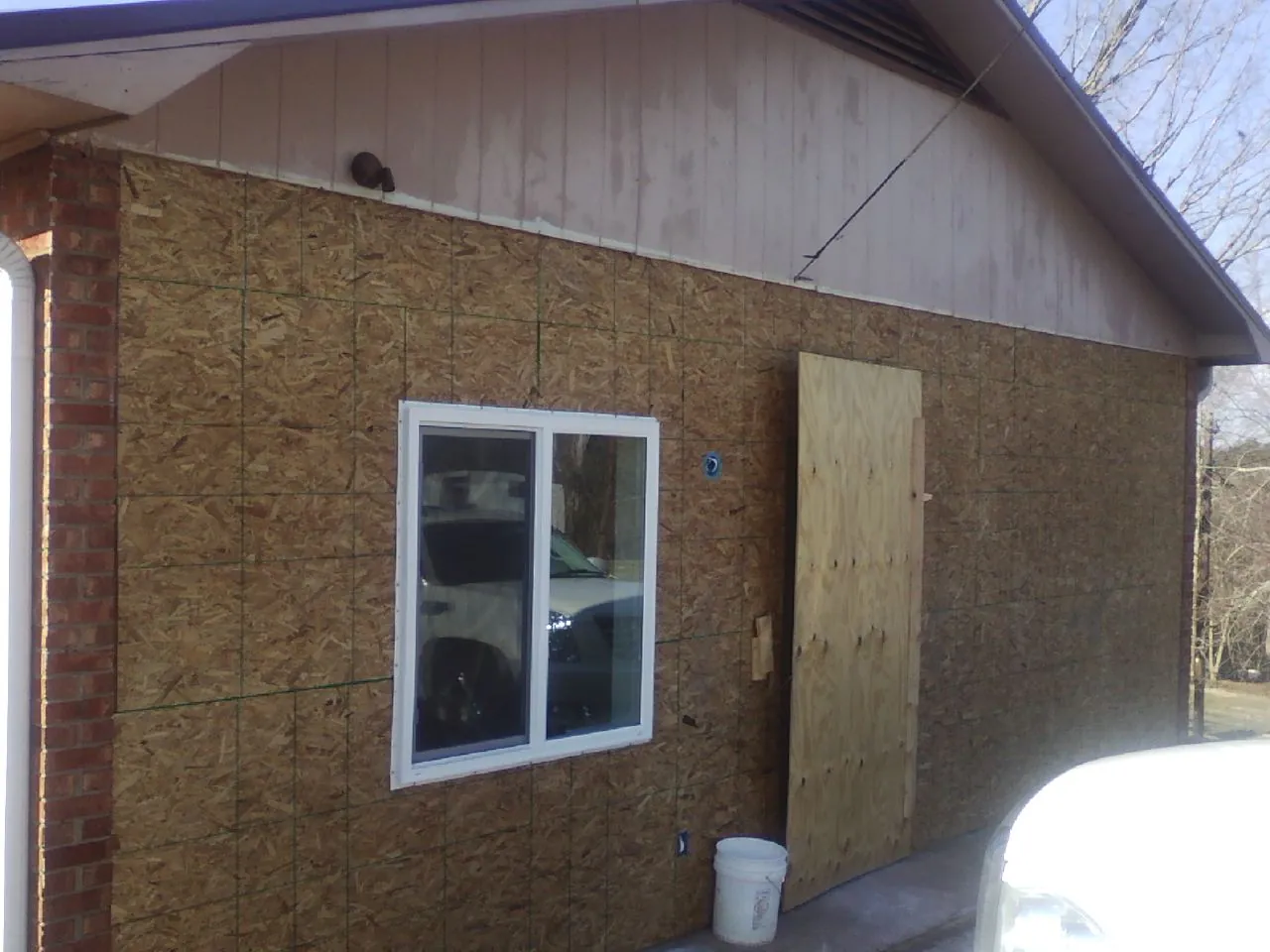 OSB sheathing on a garage addition wall before siding in Sheridan